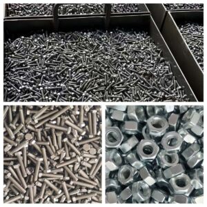 Industrial fasteners collection featuring black screws, stainless steel bolts, and hex nuts.